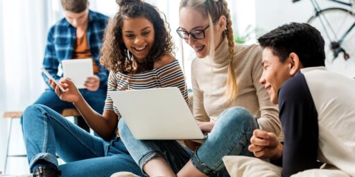 uylc hero teens sitting on couch with macbook